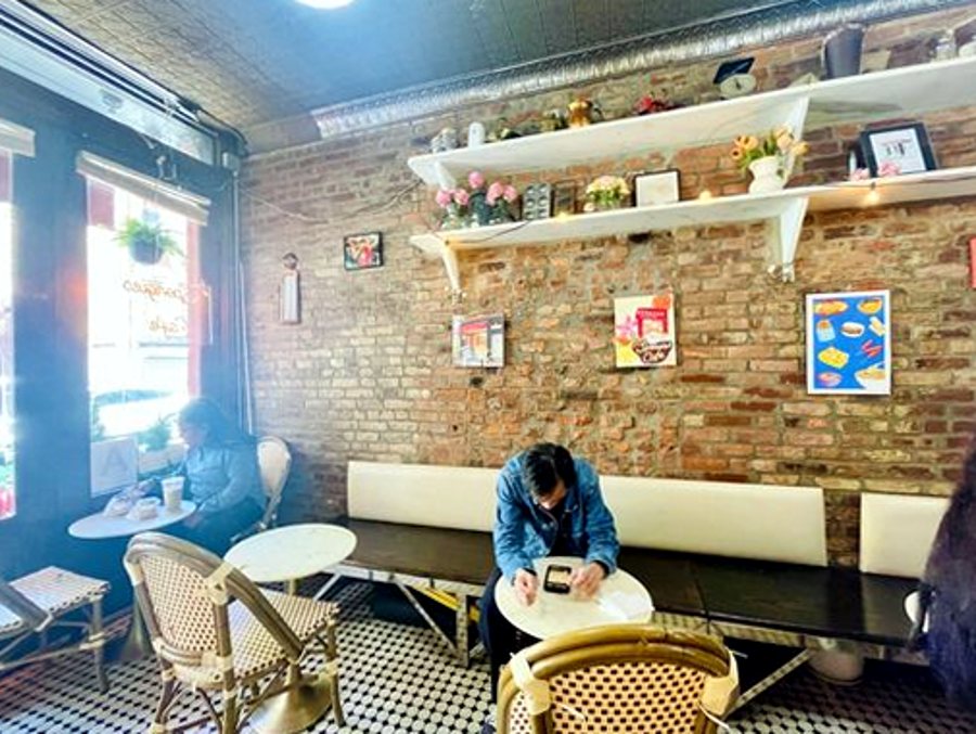 Spongies Cafe interior with tin ceiling and art-covered brick wall